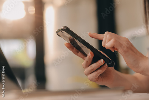 Cropped photo of Freelancer business Asian woman holding coffee cup and at doing planning analyzing the financial report, business plan investment, finance analysis the workplace.