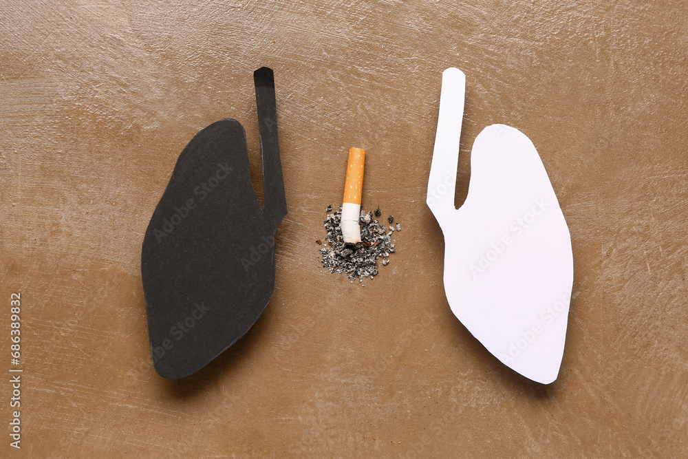 Paper lungs with cigarette on grunge background. Cancer concept Paper lungs with cigarette on grunge background. Cancer concept