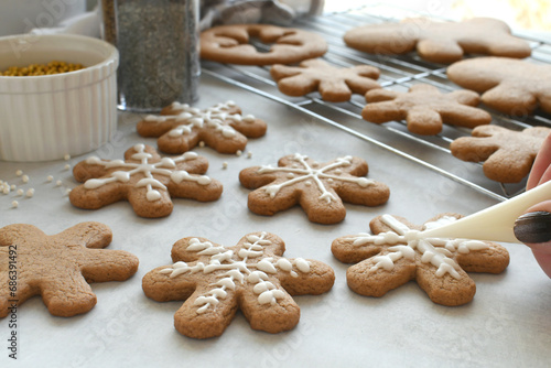 Decorating gingerbread snowflake cookies for a winter holiday party