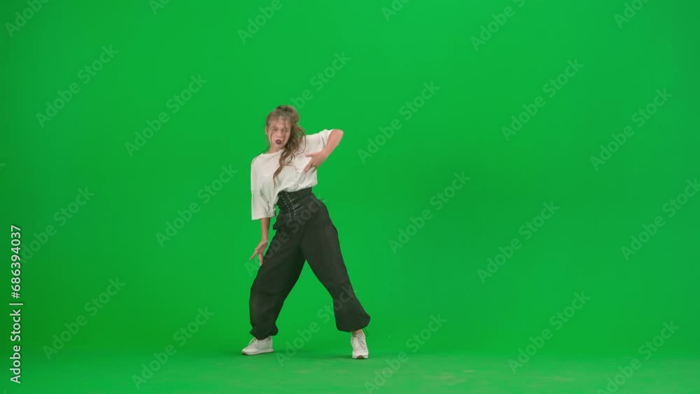 In the frame on a green background, chromakey. A young, slender, beautiful girl is dancing. She demonstrates various dance moves in the direction of jazz funk. She is rhythmic, plastic. General plan In the frame on a green background, chromakey. A young, slender, beautiful girl is dancing. She demonstrates various dance moves in the direction of jazz funk. She is rhythmic, plastic. General plan