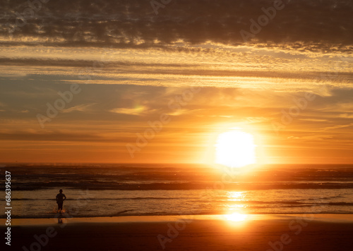 Boy Running into the Water at Sunset © Gabe