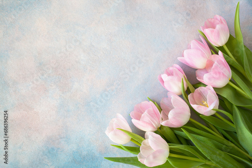 Fototapeta Naklejka Na Ścianę i Meble -  Bouquet of pink tulips on a decorative background, space for text congratulations to the spring holidays.