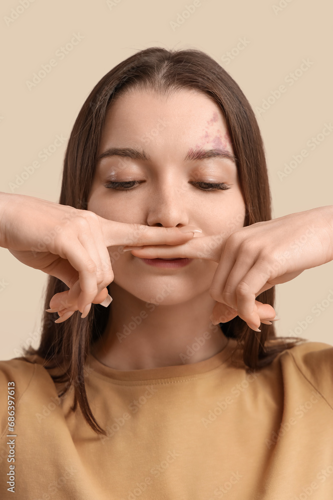 Young woman doing face building exercise on beige background, closeup Young woman doing face building exercise on beige background, closeup