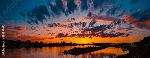 High resolution stitched summer sunset panorama with reflections near Deggendorf, Danube, Bavaria, Germany