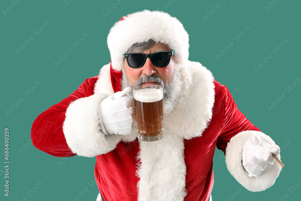 Bad Santa Claus drinking beer on green background Bad Santa Claus drinking beer on green background