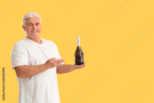 Senior man with bottle of c...