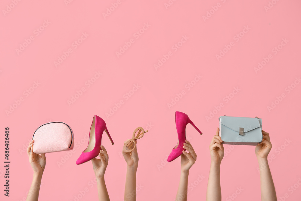 Female hands with stylish shoes and accessories on pink background - obrazy, fototapety, plakaty 