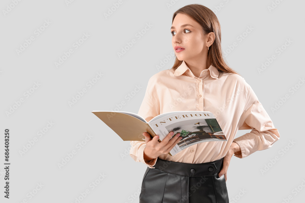 Young woman with interior magazine on white background Young woman with interior magazine on white background