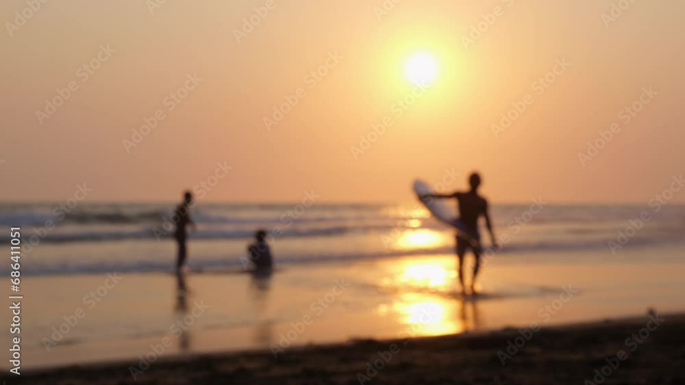 People relax carefree on seashore in rays sunset. Holidays in hot countries help forget about hustle and bustle live time carefree. Blurred frame will convey atmosphere carefree happiness of holiday People relax carefree on seashore in rays sunset. Holidays in hot countries help forget about hustle and bustle live time carefree. Blurred frame will convey atmosphere carefree happiness of holiday