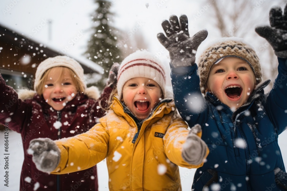 kids playing in snow in winter laughing and having fun