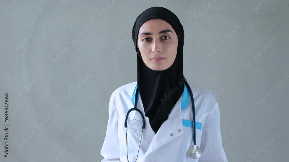 Muslim woman doctor in hijab and uniform with stethoscope Doctors Muslim confident look instills hope for recovery and wellbeing Ideal neutral background for healthcare advertising in muslim countries Muslim woman doctor in hijab and uniform with stethoscope Doctors Muslim confident look instills hope for recovery and wellbeing Ideal neutral background for healthcare advertising in muslim countries