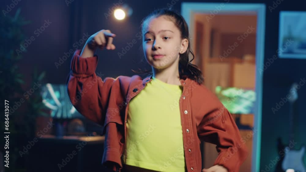 Little girl taking part in trends by sharing content of her performing viral choreography on popular hit song. Young media star doing trending dance moves inspired by other content creators Little girl taking part in trends by sharing content of her performing viral choreography on popular hit song. Young media star doing trending dance moves inspired by other content creators