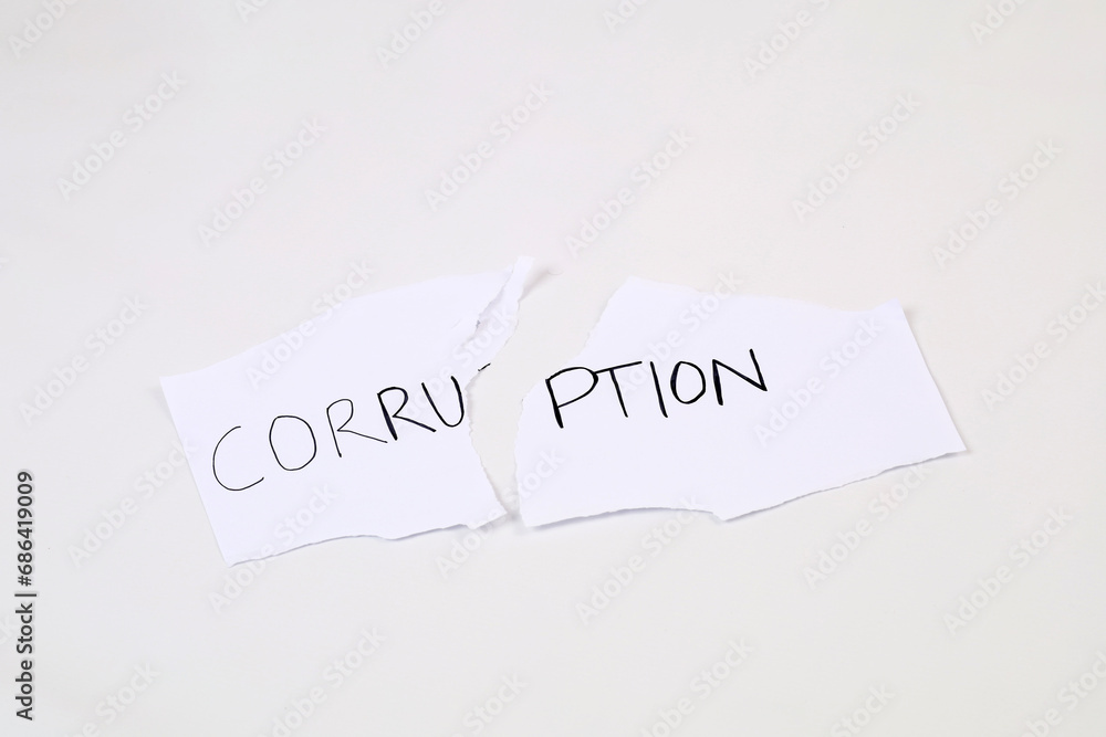 Stop and fight corruption concept. A piece torn paper with written word corruption. Stop and fight corruption concept. A piece torn paper with written word corruption.