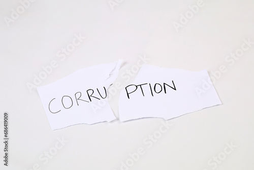 Stop and fight corruption concept. A piece torn paper with written word corruption.