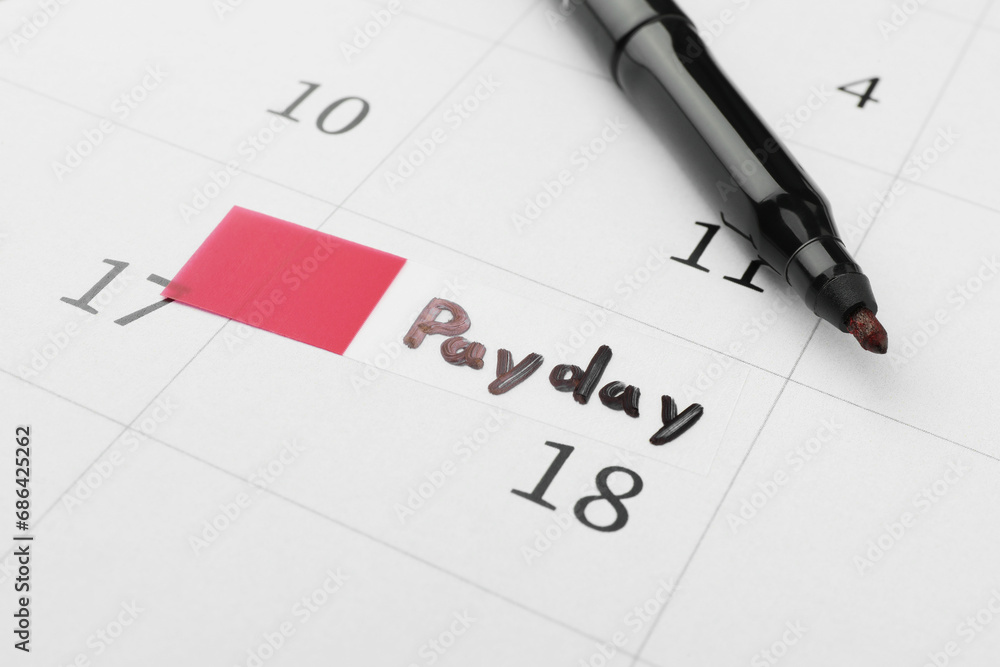 Black felt pen on calendar page with marked payday date, closeup