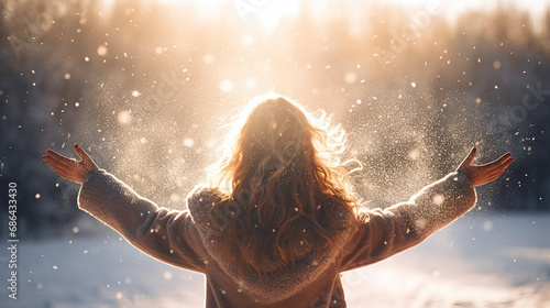 young girl throwing snow in the air at sunny winter