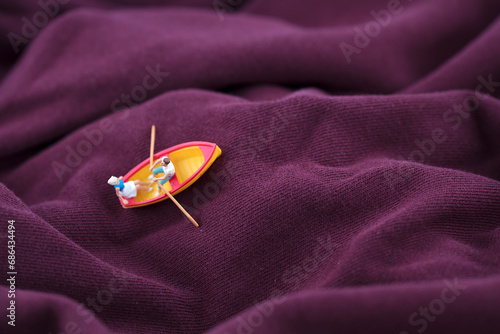 Miniature creative rowing on the fabric ocean