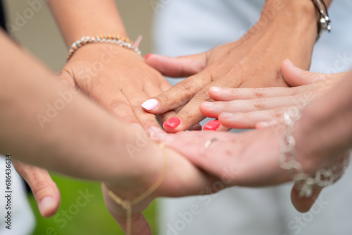Friends, support and stack of hands of people for motivation, community and friendship outdoors. Teamwork, woman together for trust, commitment and solidarity in park. High quality photo