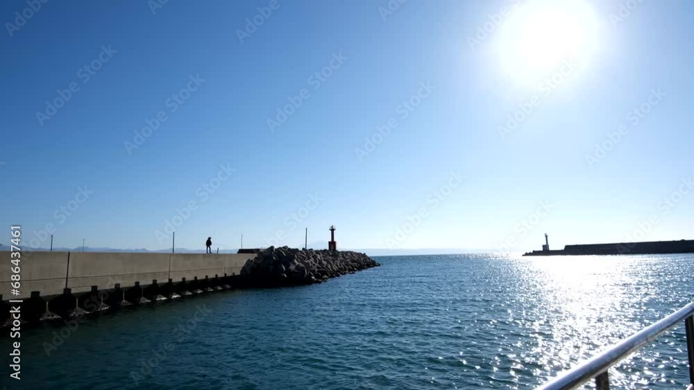 港から出て行く船から見た光景、出雲市の大社漁港、青空と太陽の光