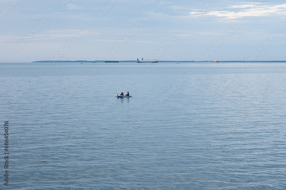 Naklejka premium Two fishermen begin their day by going out to sea in search of fish