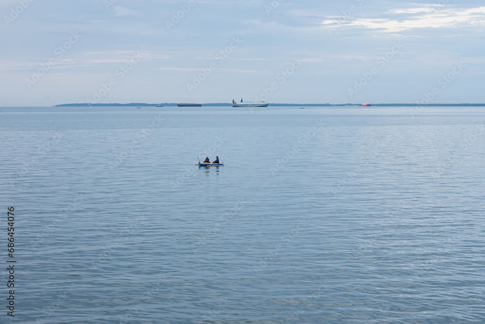 Two fishermen begin their day by going out to sea in search of fish