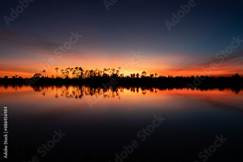 Beautiful vibrant sunset reflection at pond in Bonita Springs, Florida