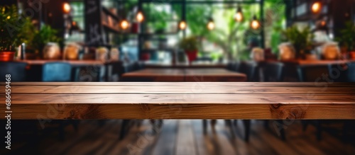 A vacant wooden table in a cafe or reception room suitable for showcasing or creating product montages photo
