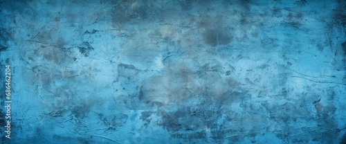 Blue decorative plaster texture with vignette. Abstract grunge background with copy space for design