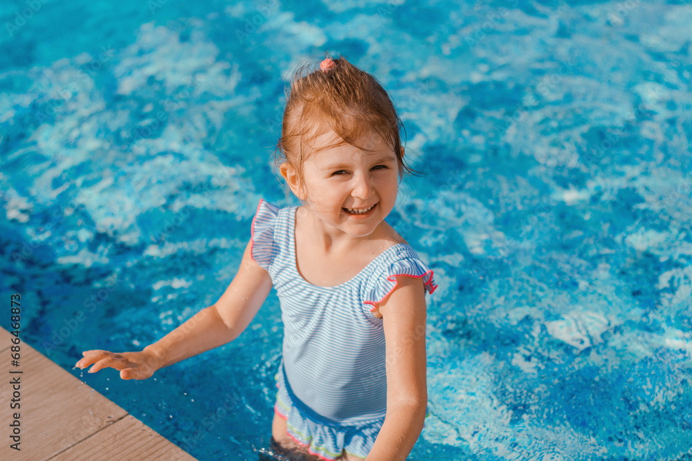 Little girl having fun in swimming pool.