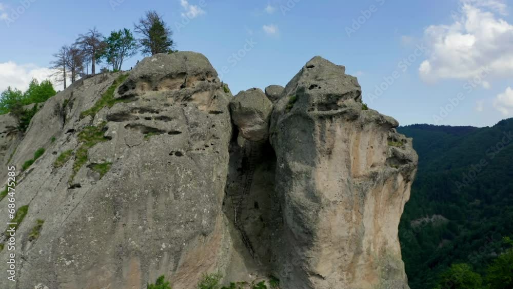 Retreating drone shot of Karadzhov Kamak, a natural rock formation venerated by the ancient Thracians as the place of the dead, located in Plovdiv province in Bulgaria. Retreating drone shot of Karadzhov Kamak, a natural rock formation venerated by the ancient Thracians as the place of the dead, located in Plovdiv province in Bulgaria.