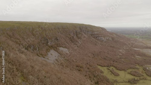 Aerial tracking over Slieve Carran hilltop reveals peak detail. Burren photo