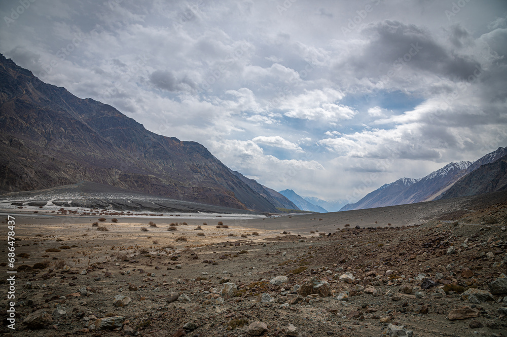 Scenic view of Himalayas and Ladakh ranges. Beautiful barren hills in Ladakh with dramatic clouds in the background. View from the road from Nubra Valley to Turuk. Siachen area in Leh Ladakh. Scenic view of Himalayas and Ladakh ranges. Beautiful barren hills in Ladakh with dramatic clouds in the background. View from the road from Nubra Valley to Turuk. Siachen area in Leh Ladakh.