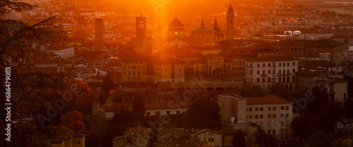 Bergamo, Italy. One of the beautiful city in Italy. Morning landscape at the old town from Saint Vigilio hill during fall season. Orange and red contest