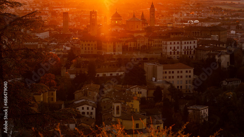 Bergamo, Italy. One of the beautiful city in Italy. Morning landscape at the old town from Saint Vigilio hill during fall season. Orange and red contest