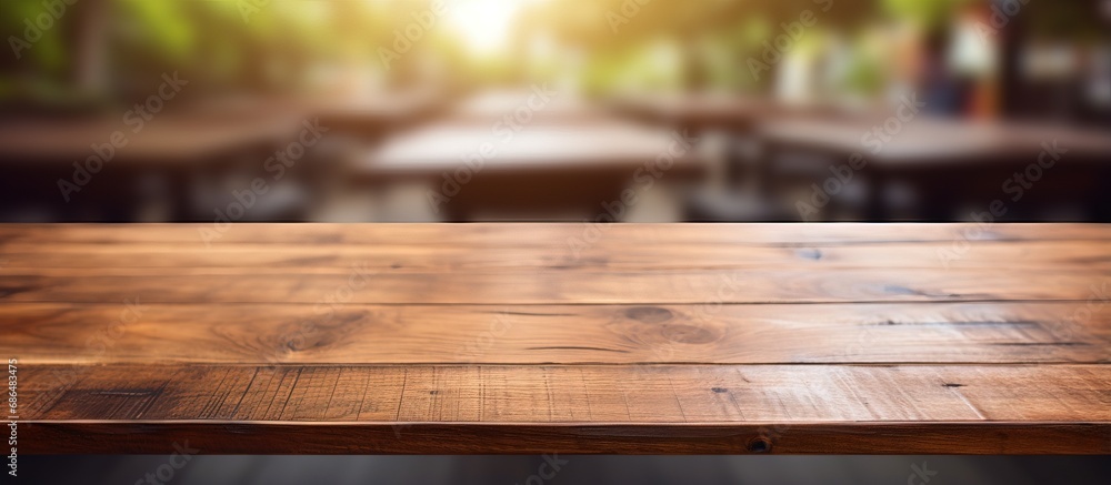 Blurry background with wooden table in closeup view Blurry background with wooden table in closeup view