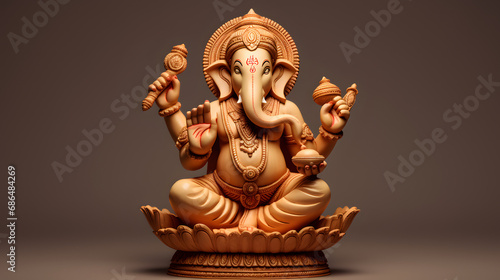Lord ganesha sclupture isolated on brown background photo