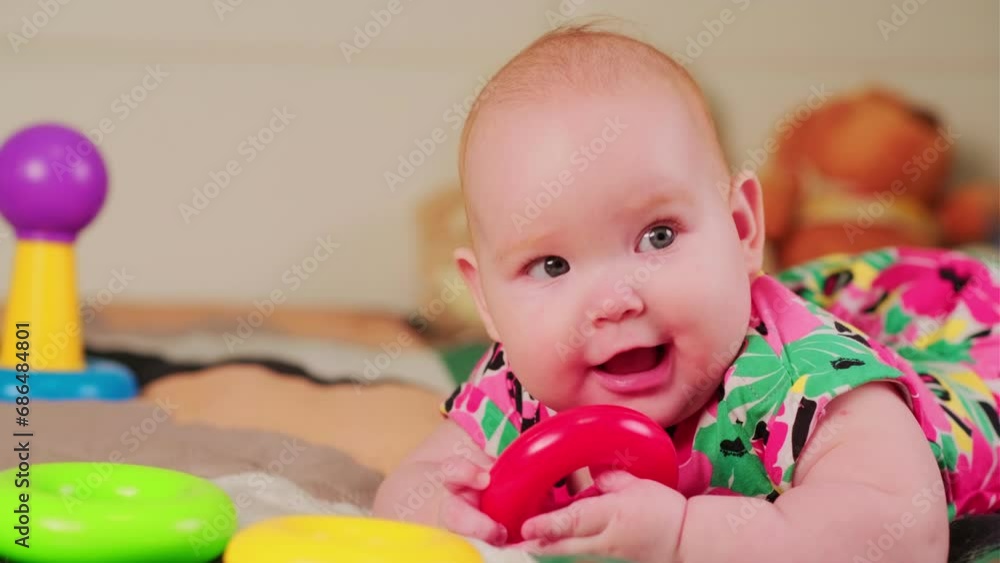 Portrait of a cute baby girl playing with colorful toys at home Portrait of a cute baby girl playing with colorful toys at home