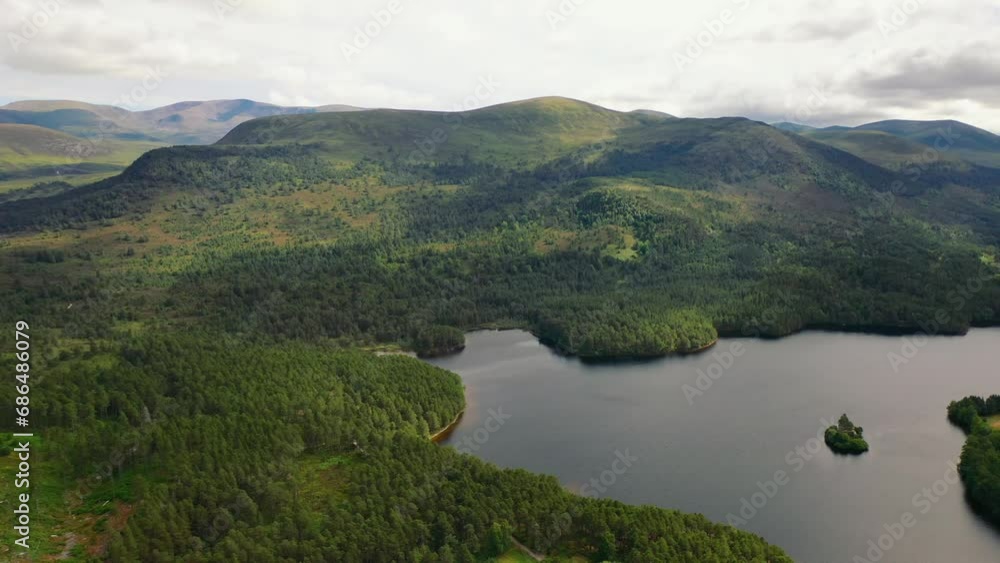 Loch An Eilein's Aerial Portrait: Scots Pine Forest Silhouettes, Aviemore in the Scottish Highlands, Scotland, United Kingdom Loch An Eilein's Aerial Portrait: Scots Pine Forest Silhouettes, Aviemore in the Scottish Highlands, Scotland, United Kingdom