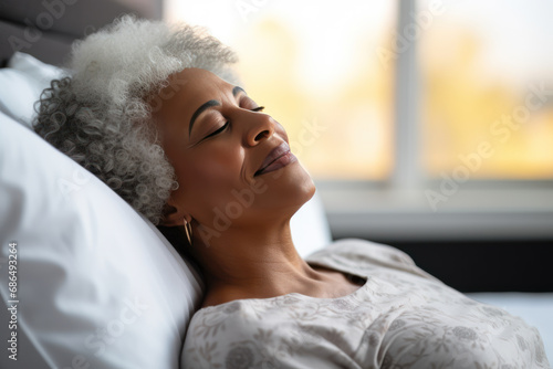 Senior afro american woman sleeping well on white pillow in bed