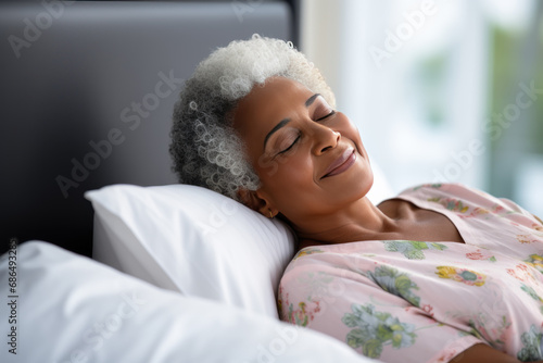 Senior afro american woman sleeping well on white pillow in bed