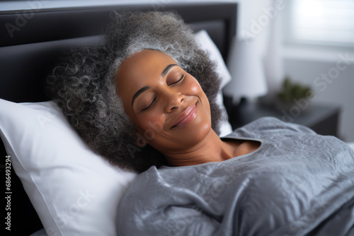 Senior afro american woman sleeping well on white pillow in bed