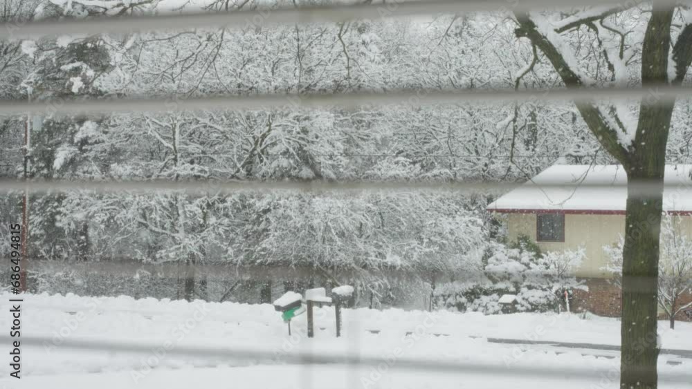 viewing a snowstorm out of a window with the window frame in the shot viewing a snowstorm out of a window with the window frame in the shot