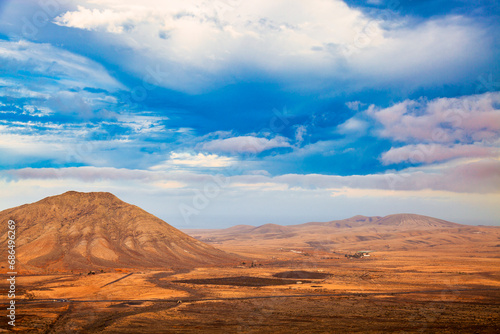 A beautiful natural landscape with mountains and a clear blue sky.