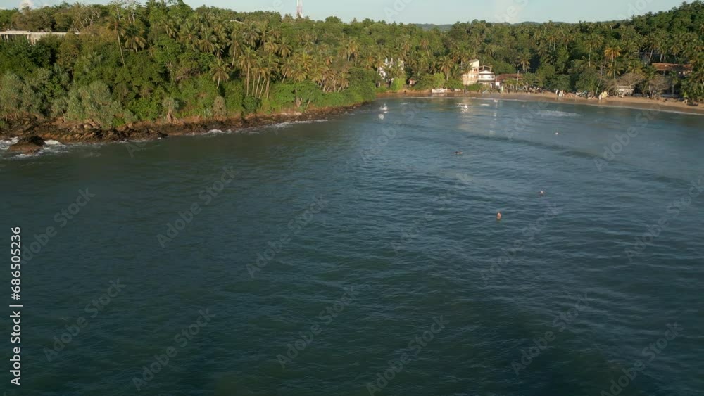 Establishing Aerial Drone Shot of Hiriketiya Beach and Bay with Surfers in the Water Establishing Aerial Drone Shot of Hiriketiya Beach and Bay with Surfers in the Water