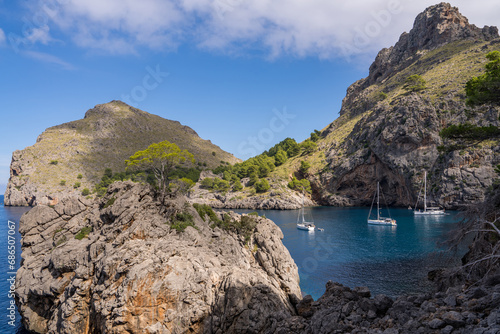 Beautiful views of the coastline at Port de Soller, with three yachts in a quiet harbour. on the island of Mallorca, Spain, Mediterranean Sea photo
