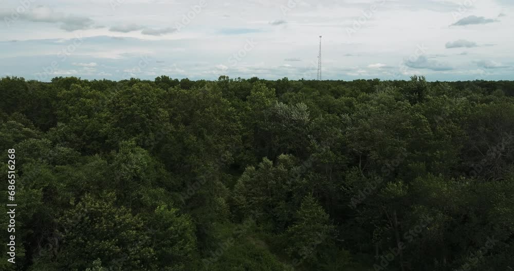 Daytime scenery seen from a drone - lattice tower overlooking the wilderness. Daytime scenery seen from a drone - lattice tower overlooking the wilderness.