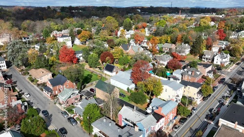 Small town America during autumn. Aerial establishing shot of houses and homes amount fall foliage. photo
