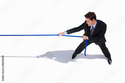 Businessman, conflict and tug of war by white background, career challenge and workplace competition. Young person, mental health and professional worker with rope, top view and job battle in studio