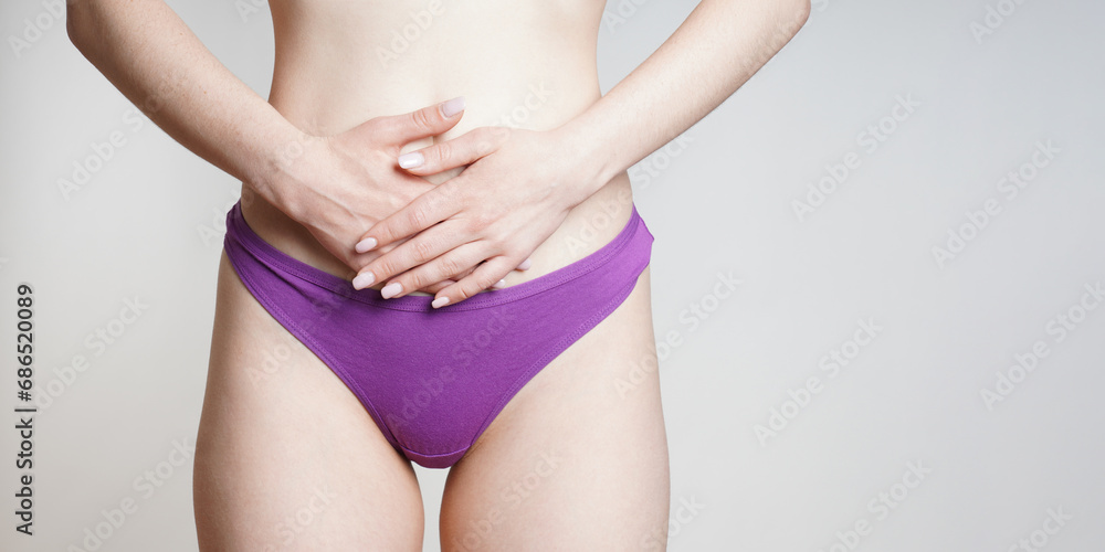 woman in panties holding belly with abdominal or period pains