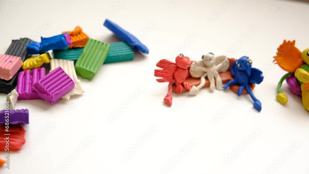 Child making colorful plasticine dragons family and creating. Fairy tale card with cartoon animals.